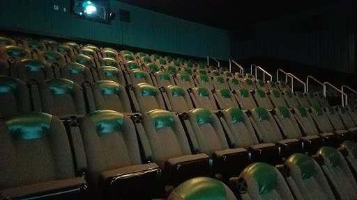 A before-and-after of one of the theaters on April 1, 2025. The theater is bright due to the collapsed roof that allows light to shine on the graffiti-covered seats.(Erin Cater/Fresh Take Georgia)